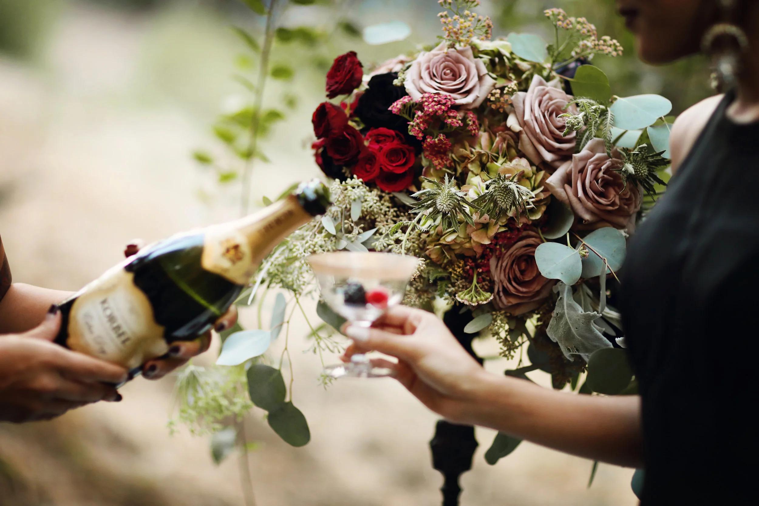Floral centerpiece with black dahlias, gold rimmed champaign goblets from Birdie in a Barn.