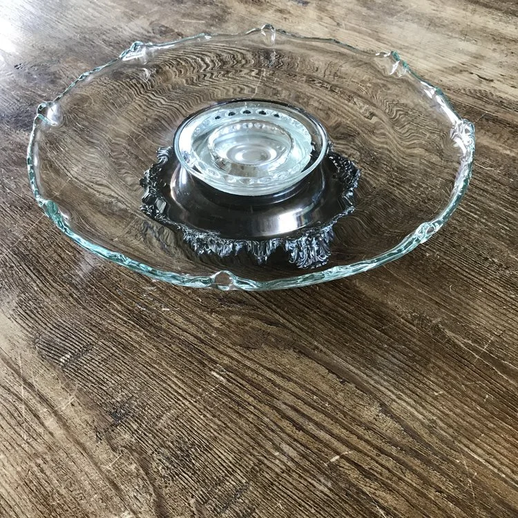 Crystal and Silver Cake PlateOrnate silver pedestal with crystal scalloped edge top. Revolving. 13" wide x 4" tall.