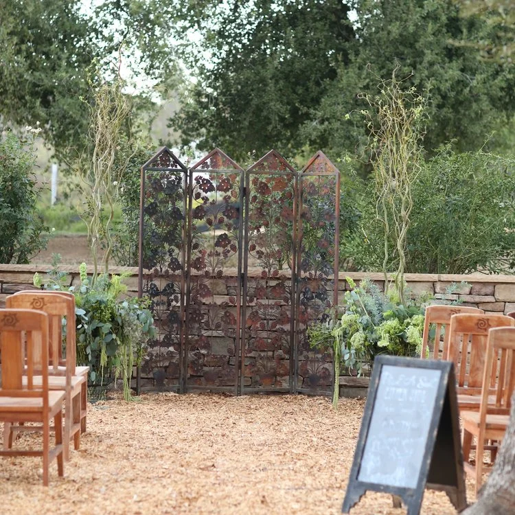 Metal rusty grapevine backdrop for a wedding ceremony. Vintage rentals in Murrieta.