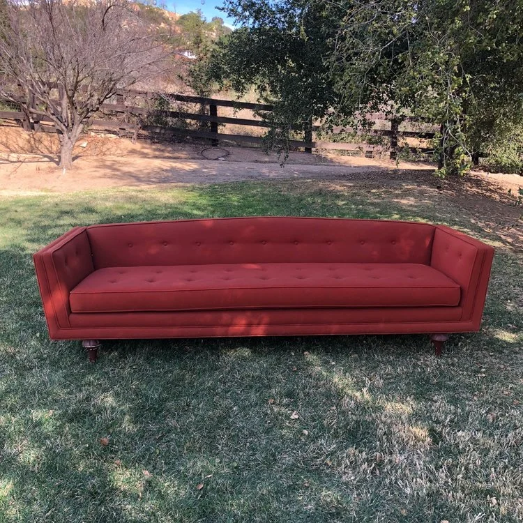 Winona Original vintage Mid-century modern couch. Pulled straight from a house that time forgot. Tufted, single pillow seat, straight legs, rad orange color. Low profile back and arms. This couch will be a conversation piece at your wedding. 96" Long x 30" wide x 26" high.