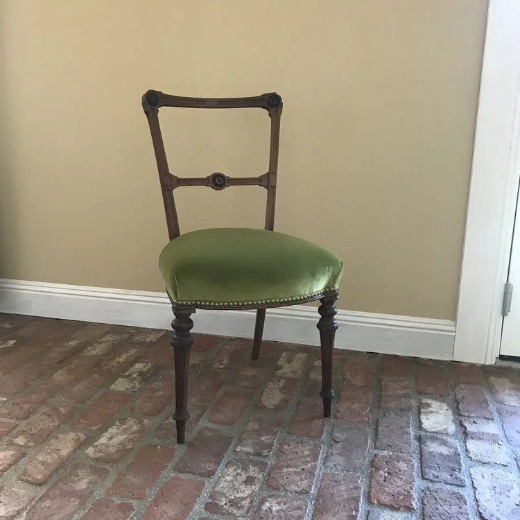 Rhett Petite green velvet chair complete with brass nailhead and vintage carvings. Throw a pillow on him and show him off. 33" tall x 18" wide. Seat 18" square.
