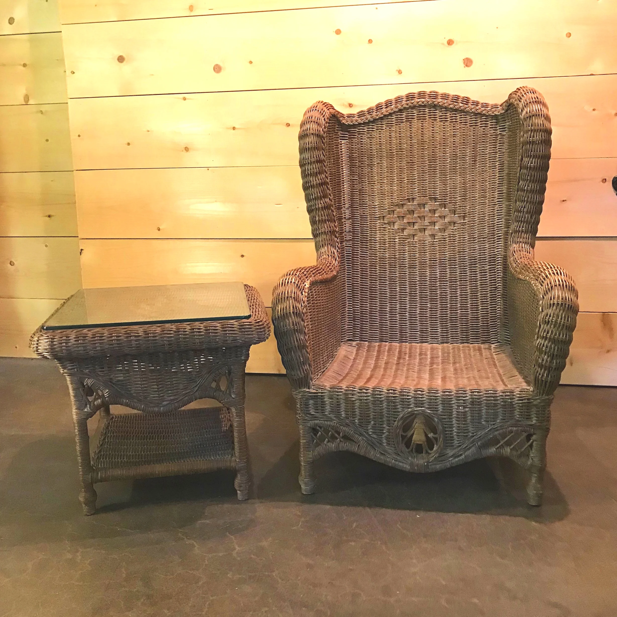 Sandra Brown tightly weaved wicker chair set and a wicker side table with a glass top. The two chairs measure 44” high x 31” wide x 21” deep. Table 20” high x 23” square