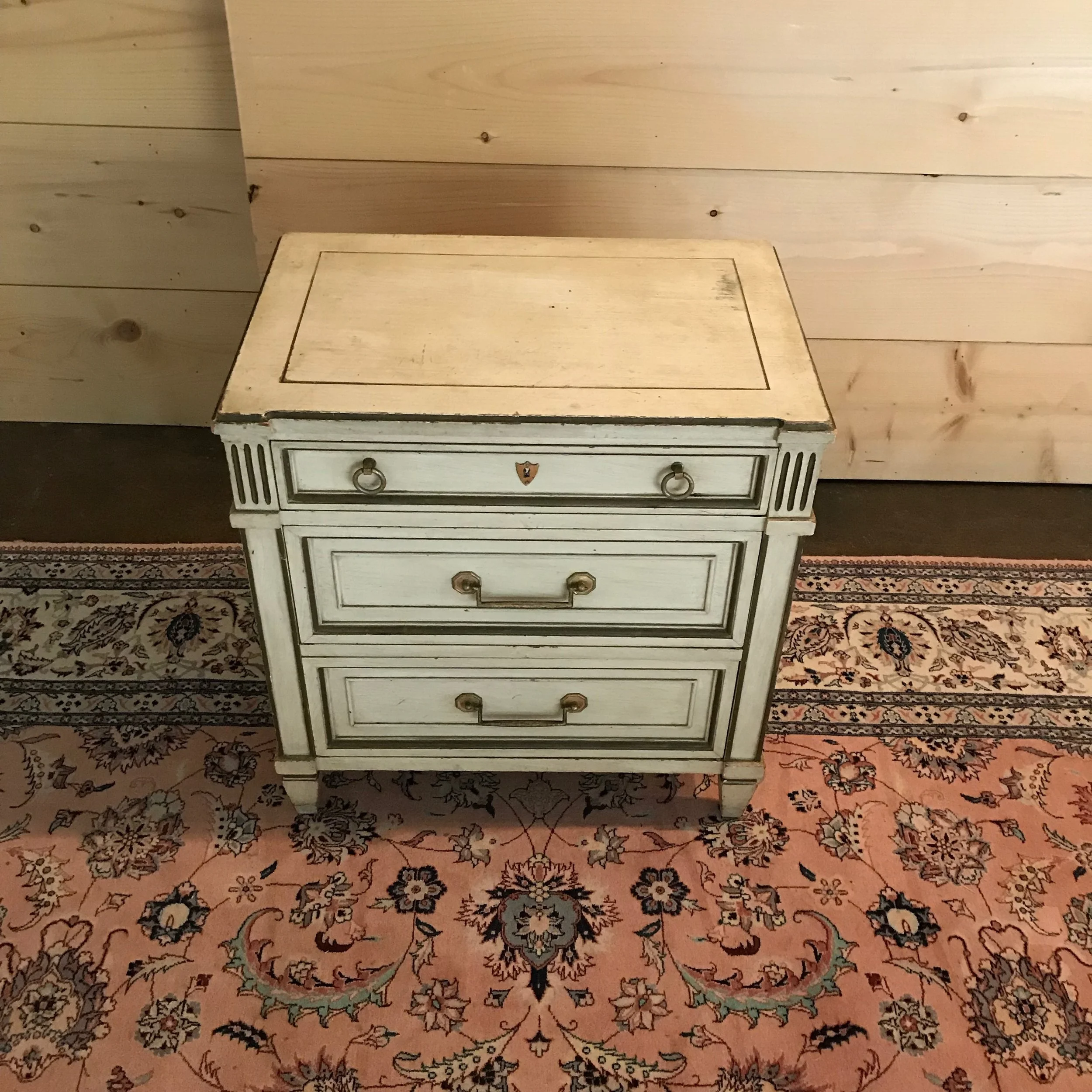 AidenShabby Chic side table with three drawers. Distressed white with gold leafing.