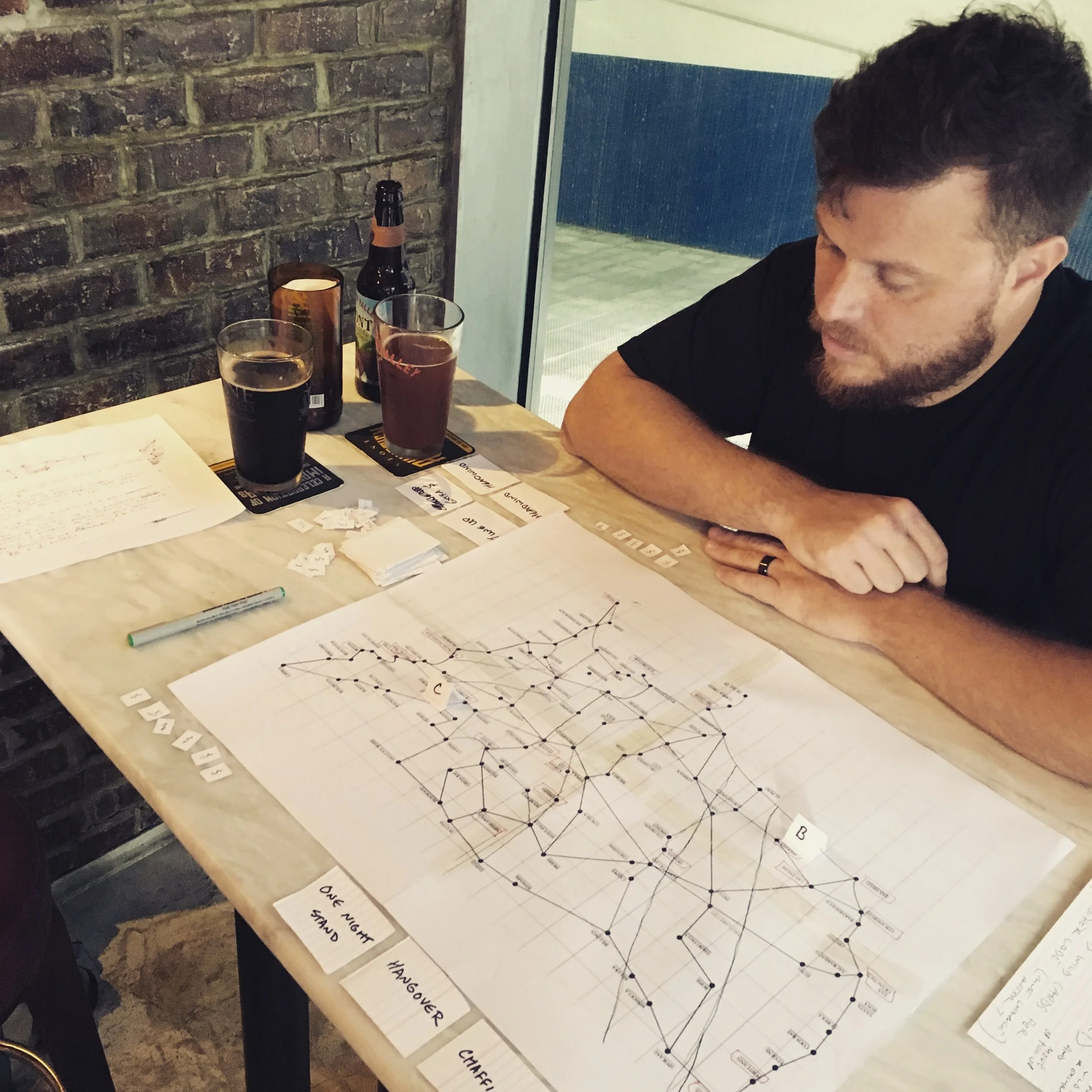 A bigger version of our first map with our "grid" idea placed over it. We quickly scrapped that plan. You can see the small markers and cards finally being used.
