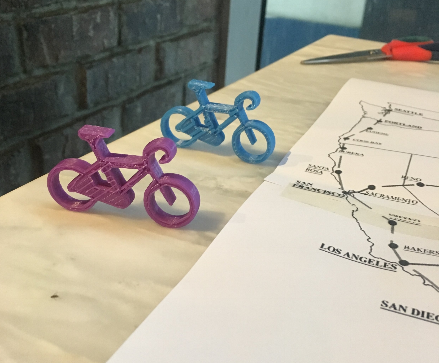 The first playing pieces! Got a 3D file of a bicycle from GradCad.com and used our school's 3D printing machine to print them out (we are both teachers).