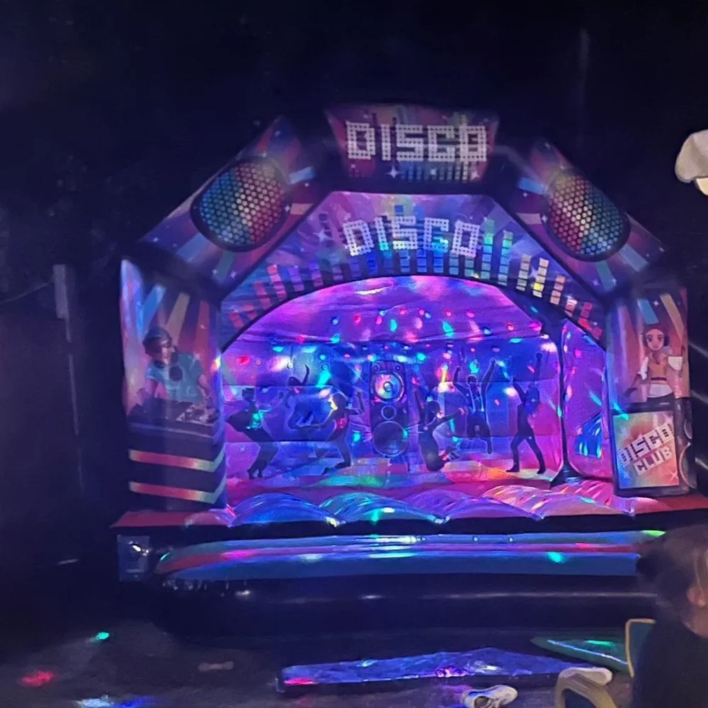 disco bouncy castle lit up at night Lewes