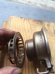 Throw-out clip and retainer on the left, Throw-out bearing on the right