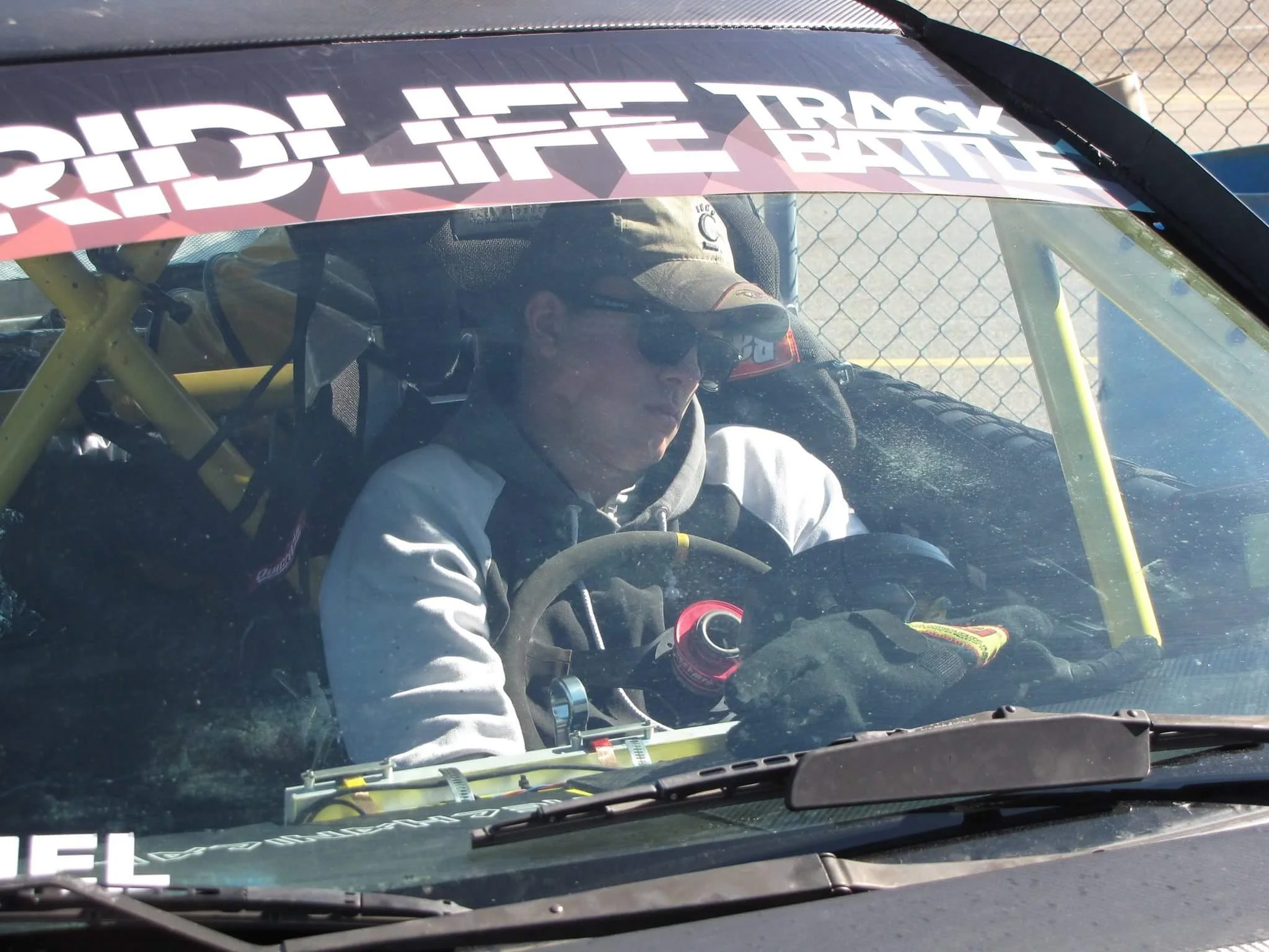 Grant getting steering wheel cuddles from his exhaustion as pit crew