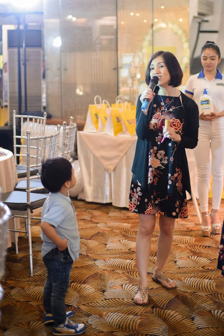 My ever beautiful friend Princess Velasco-Rosario rendering a few lines of With a Smile at the Bring Me game, while her son Kobe looks on adoringly. <3