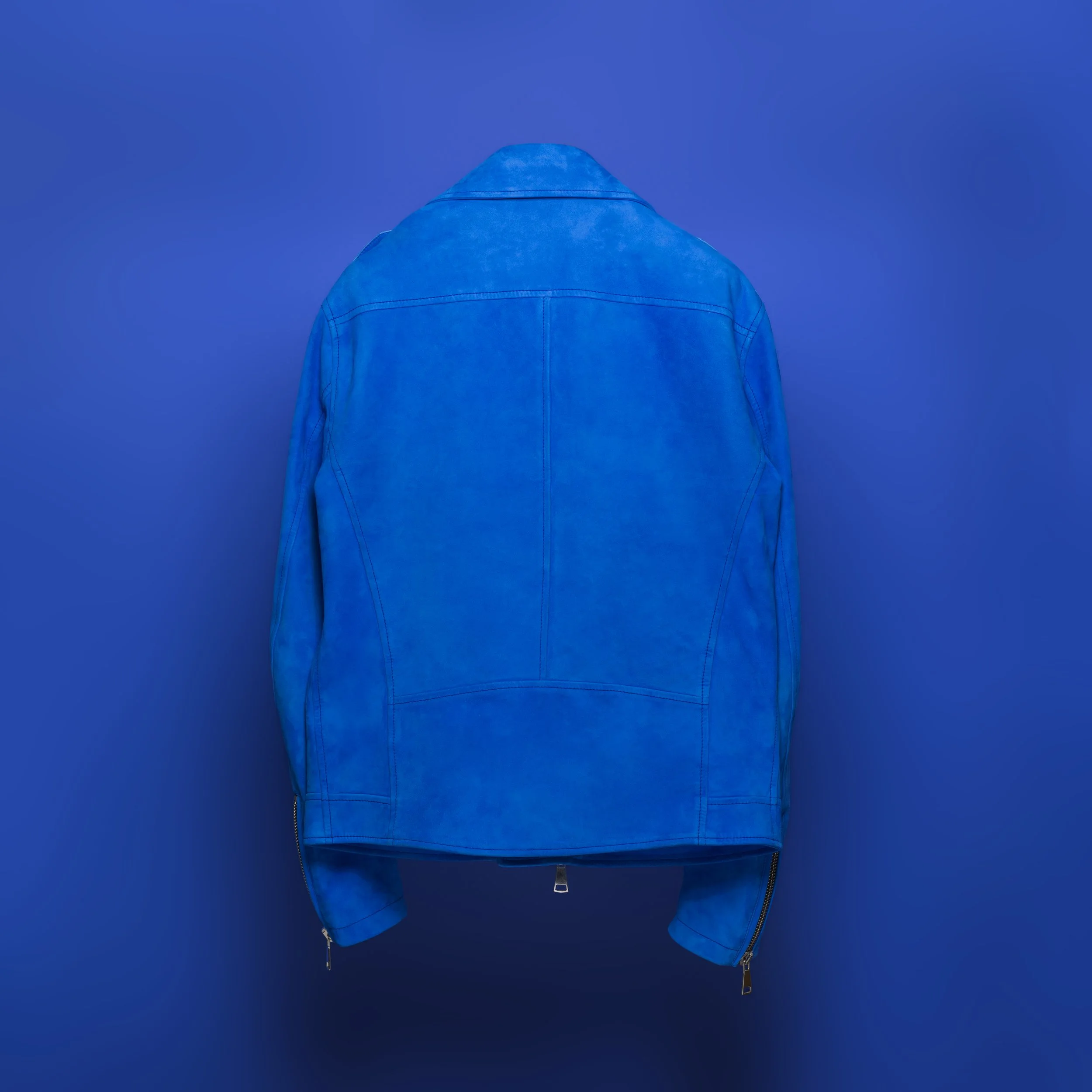 Back view of a blue leather jacket against a blue background.