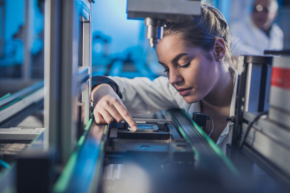 Female-engineer-examining-machine-part-on-a-production-line.-681697244_2125x1416.jpeg