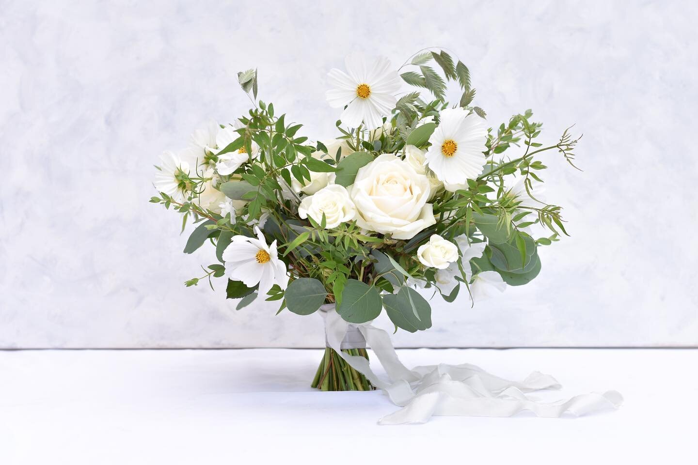 Danielle&rsquo;s pretty white and green bouquet filled with roses, stocks cosmos, grasses and jasmine for her rustic blessing to Ben in August 🤍