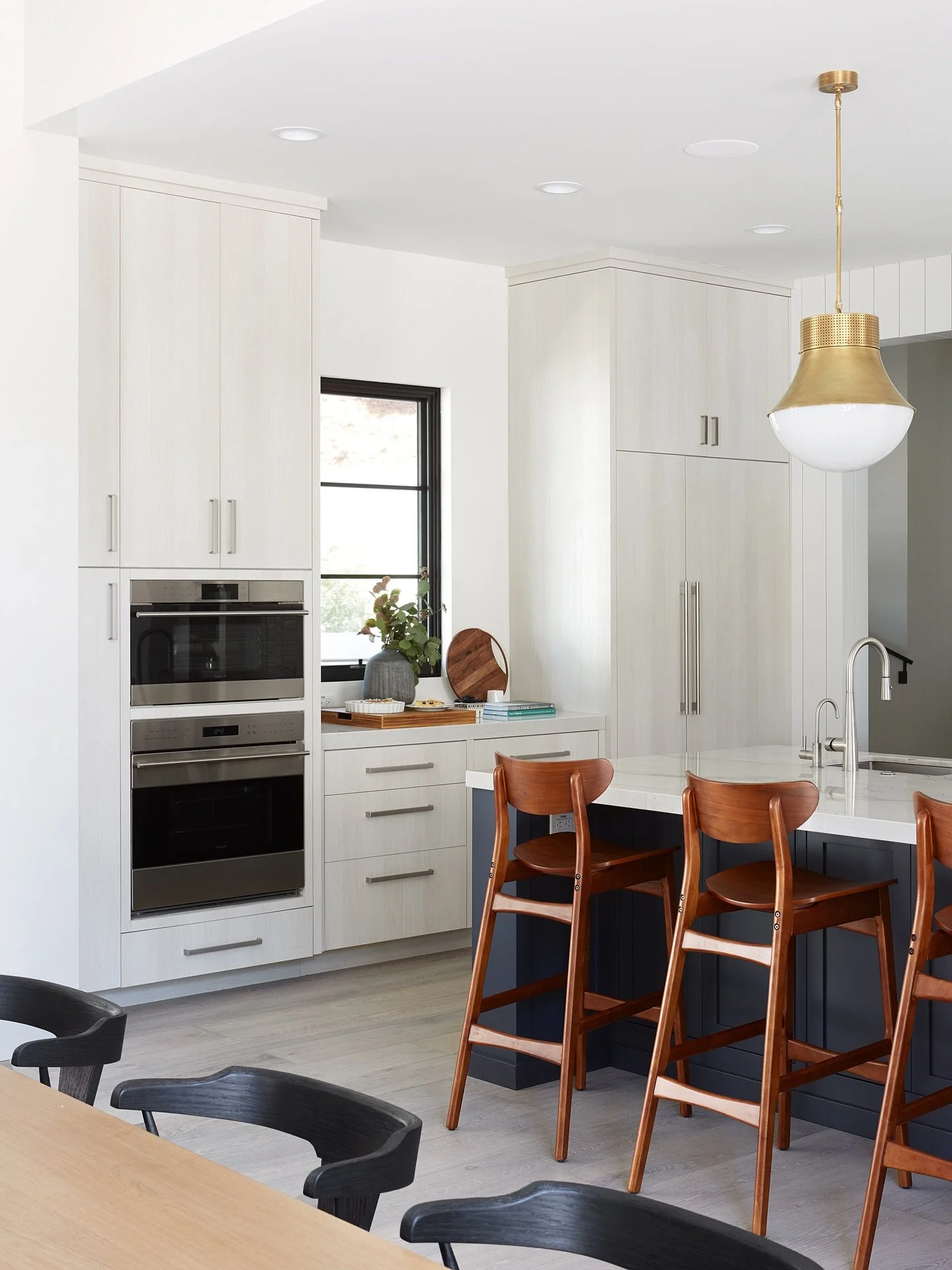 A modern kitchen designed for both beauty and function.

Warm wood tones, clean-lined cabinetry, and a statement brass pendant bring natural texture and timeless style into the space. The combination of light finishes and bold contrasts creates a kit