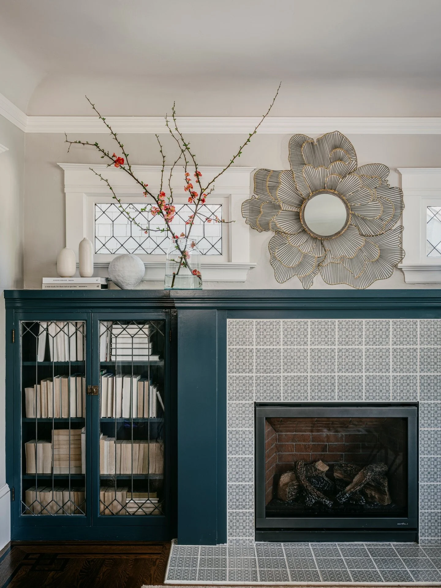 Sometimes the smallest corner of a home becomes the one that defines the entire mood.

This fireplace was reimagined with deep, saturated millwork, soft pattern, and a few sculptural details that bring clarity to the room while preserving its origina