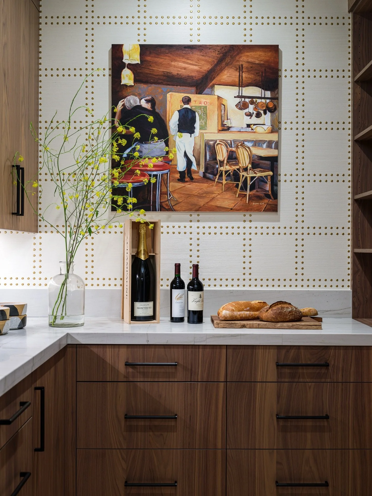 There&rsquo;s something about the holidays that makes a space like this feel even more alive.

Warm walnut cabinetry, a studded wallcovering that catches the light, and a collected mix of art, wine, and fresh bread &mdash; all the ingredients of a ho