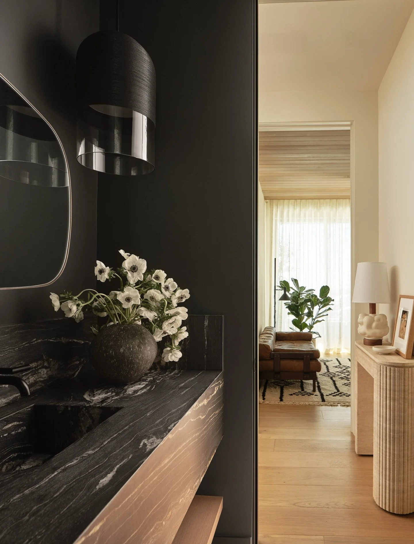 A powder room should feel like a small surprise &mdash; a space with its own mood, its own presence, its own moment of quiet drama.

In this Sausalito home, we paired deep, veined stone with warm timber tones to create a space that feels both modern 