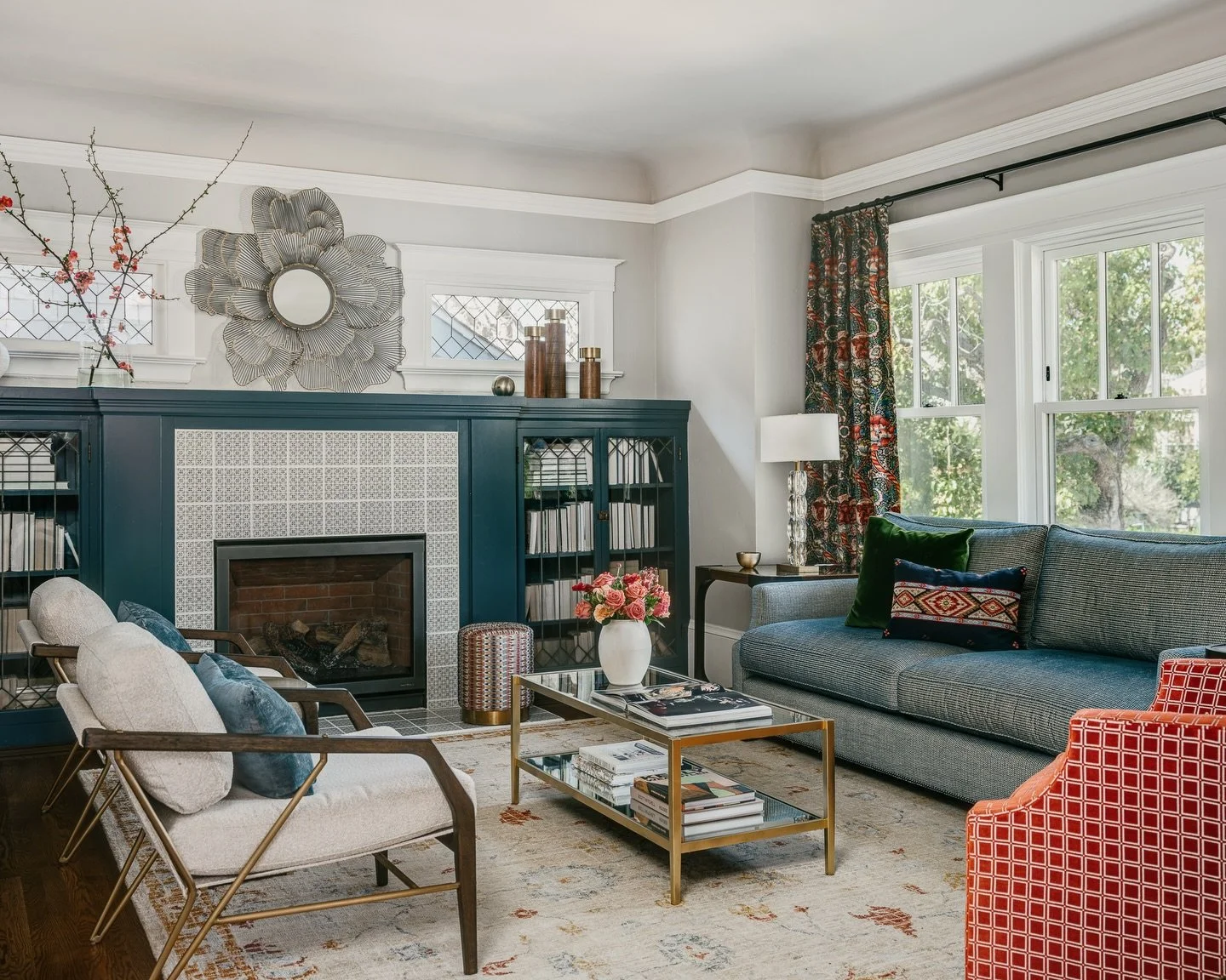 A living room designed for both gathering and pause.

This space was layered intentionally &mdash; rich cabinetry to ground the room, patterned textiles to bring warmth, and color used with restraint to create balance rather than noise. Every element