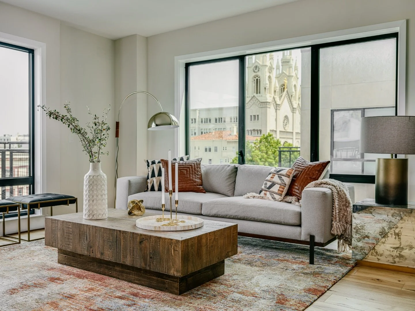 A living space shaped by balance &mdash; comfort, light, and restraint.

This room was designed to feel grounded yet open, with warm wood tones, layered textiles, and furniture scaled for how the space is actually lived in. Large windows frame the ci