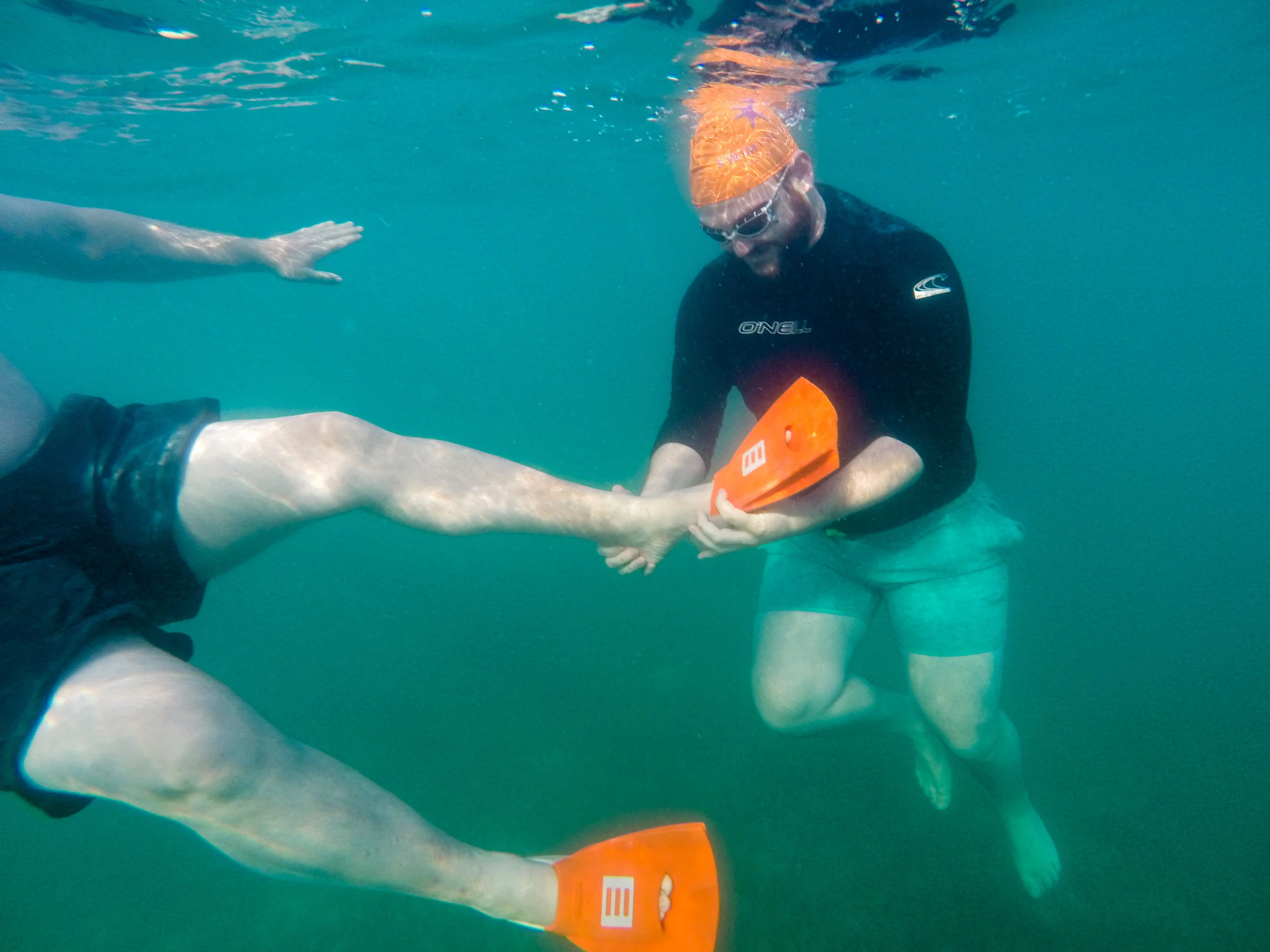 Hugh Jr helping Hugh with his fins before our first swim.