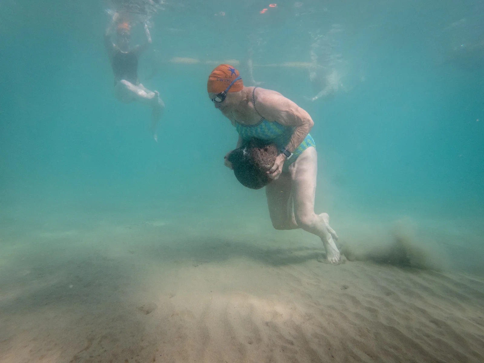 80 year old Luise wowed and amazed us with her running of the 40 lb rock in 12 feet of water.