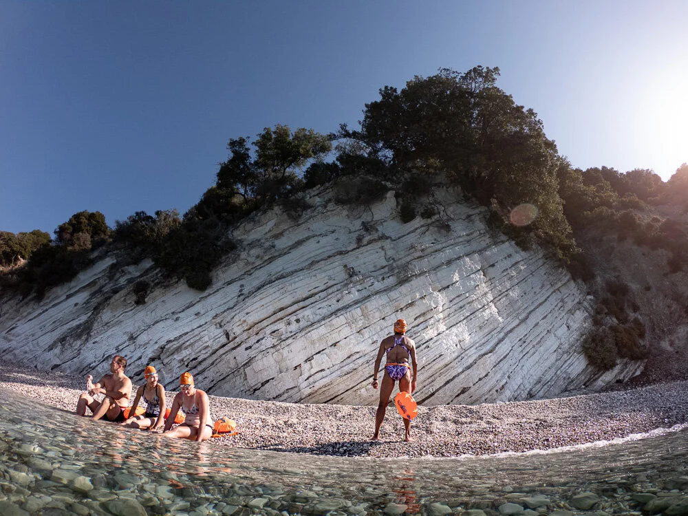 The gang enjoys the beach while Natalie eyes another climb…..