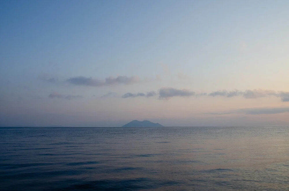 I woke late, past the best of the sunrise. But the sky was still soft with pinks and blues in the waters beyond Gidaki beach where we spent the night.
