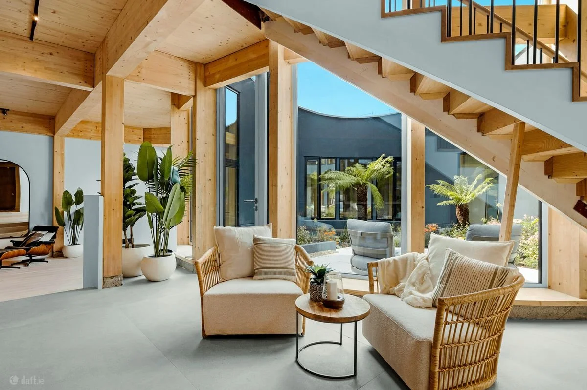 Rattan armchairs beside O House’s circular courtyard, with home staging by MKOD