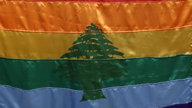 The gay pride/flag of Lebanon waives during a protest inside Beirut in 2013 (AFP/FILE)