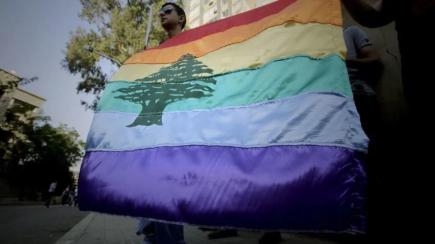 A gay pride flag is carried by human rights activists during an anti-homophobia rally in Beirut on April 30, 2013. Source: AFP
