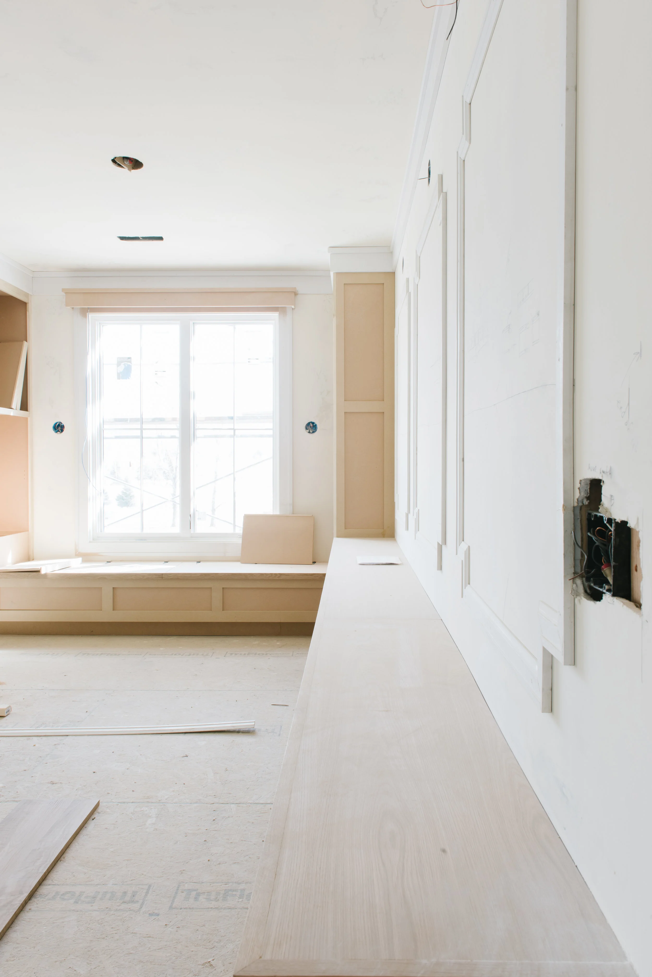 WINDOW SEAT WITH LIBRARY AND MILLWORK FRAMES FOR FRAMED ART