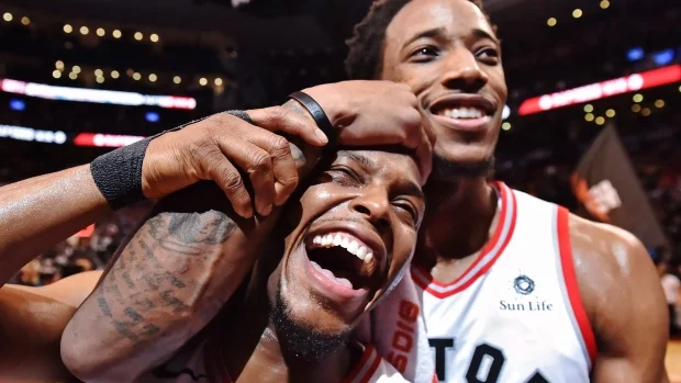 DeMar DeRozan and Kyle Lowry celebrating this historic win for the Raptors franchise
