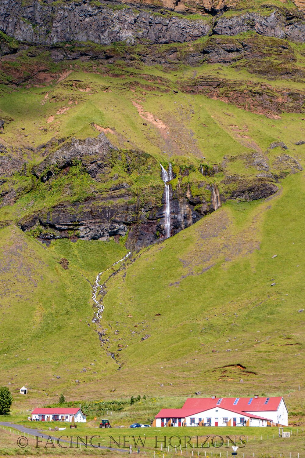  Small waterfall flowing behind a house 