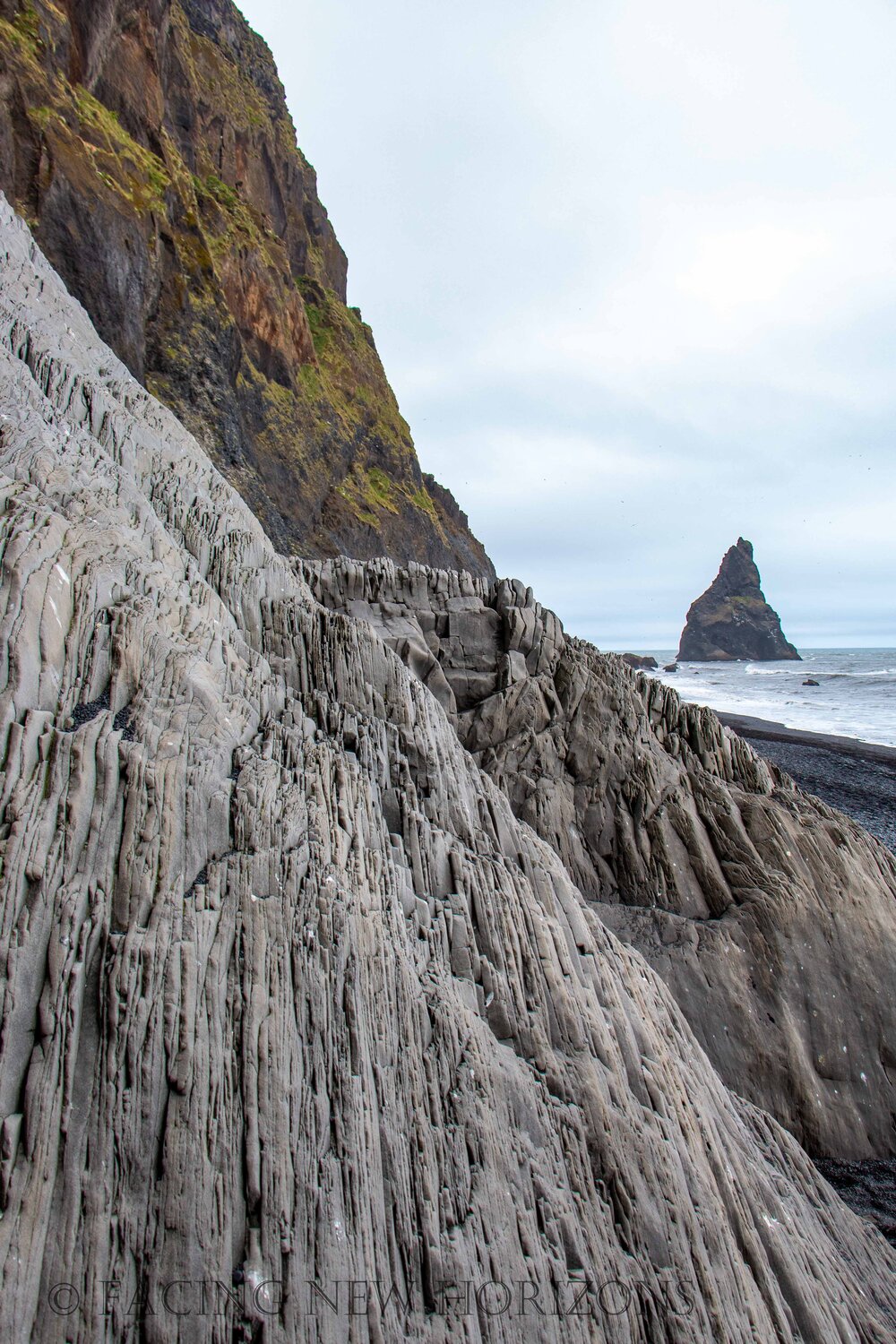  Edges of the rock cliffs with Reynisdrangar in the distance 