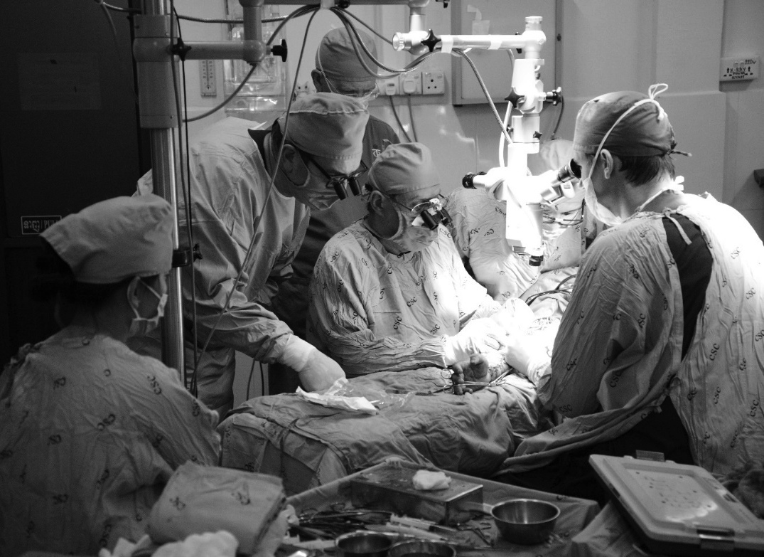 2014 hand surgery mission to Phnom Penh, Cambodia: Dr David Stewart (right, Royal North Shore Hospital) operating with Prof Neil Jones (USA) and A/Prof Graham Gumley (Australia), assisted by a local Cambodian scrub nurse.