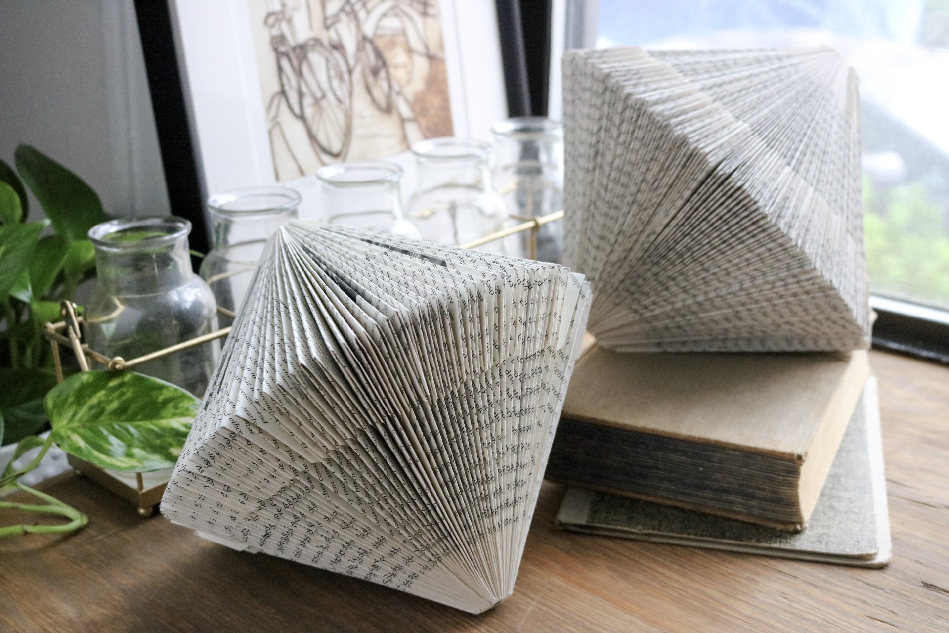 DIY Upcycled Folded Book Sculptures - Take old books or damaged books and turn them into a work or art by creating folded book art paper sculptures!  #falldiy #paper #bookworm #homedecor #falldecor #backtoschool #origami #papersculpture