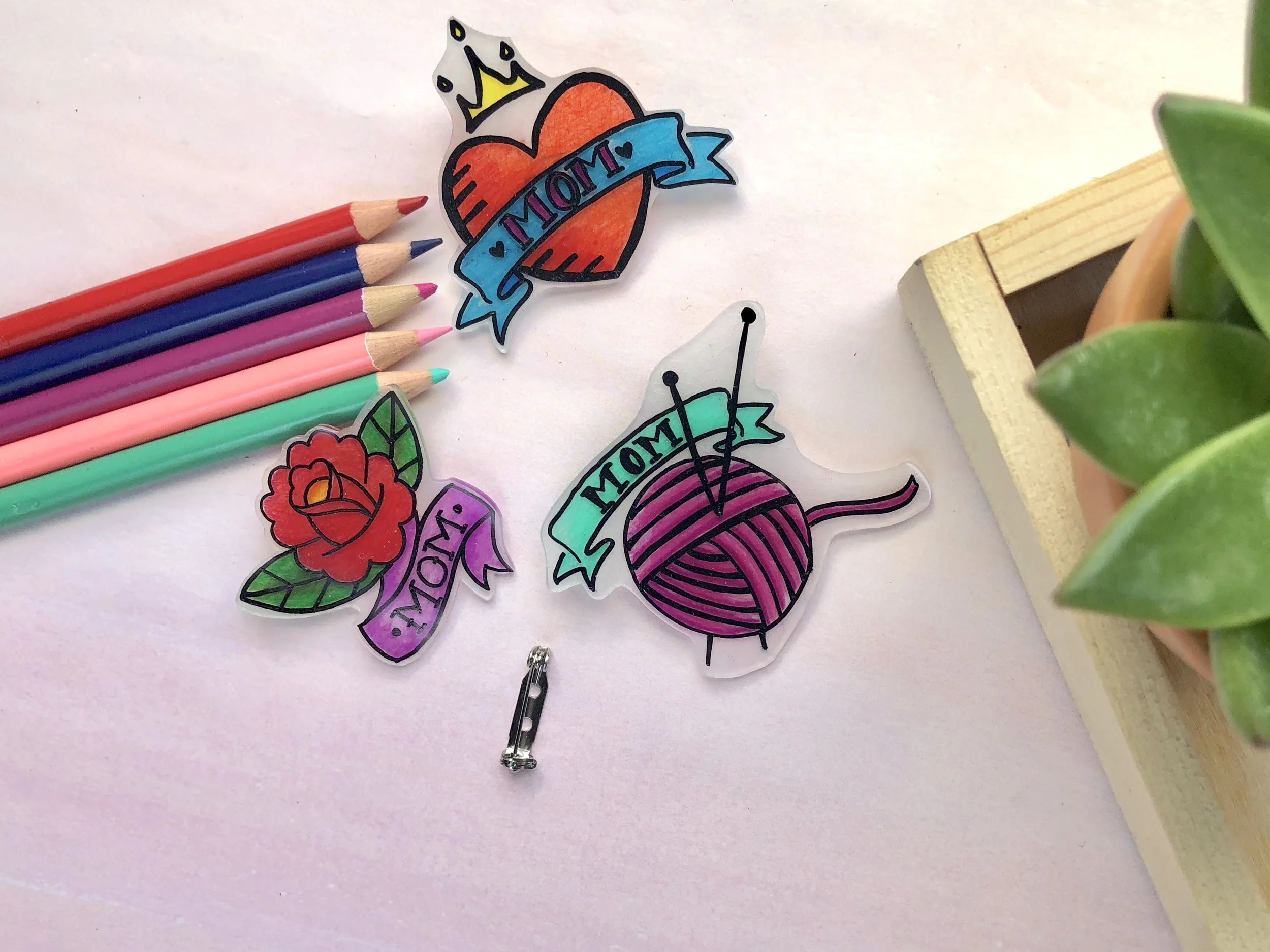 Mother's Day Shrinky Dink Mom Tattoo Pins #mothersdaydiy #mothersdaygifts #shirnkydinks #shrinkydink #shrinkydinkideas #diypin #diybrooch #momtatto #momsday #handmadegifts #giftsformom #giftsforher #badassmom #craftymom #badasswomen #womansrights #futureisfemale