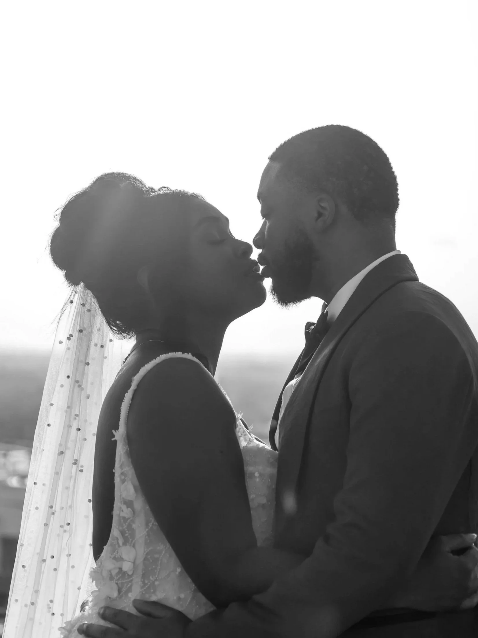 Bride and groom share a kiss on a rooftop after saying I do to each other at the alter. This magical moment during sunset is absolutely breathtaking.