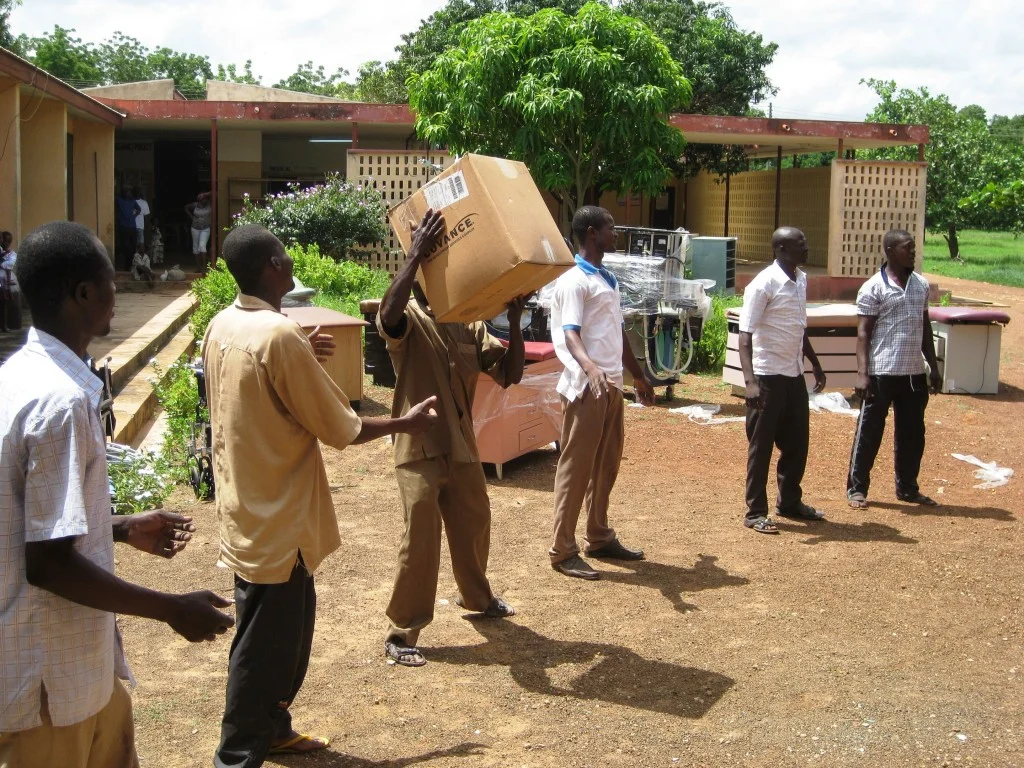 Community Members and Health Staff Working Together to Unload The Supplies