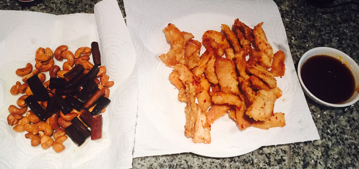 Nuts, dried chilis & chicken after frying - oyster, soy & chili paste sauce to side
