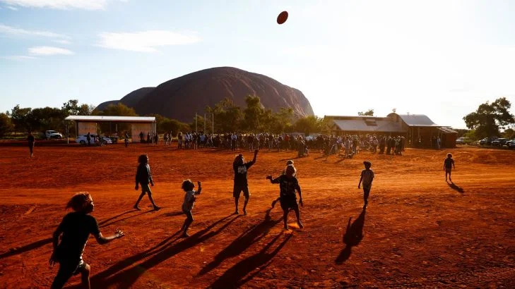 Children playing footy during the closing ceremony in the Mutitjulu community of the First Nations National Convention held in Uluru. Photo: Alex Ellinghausen