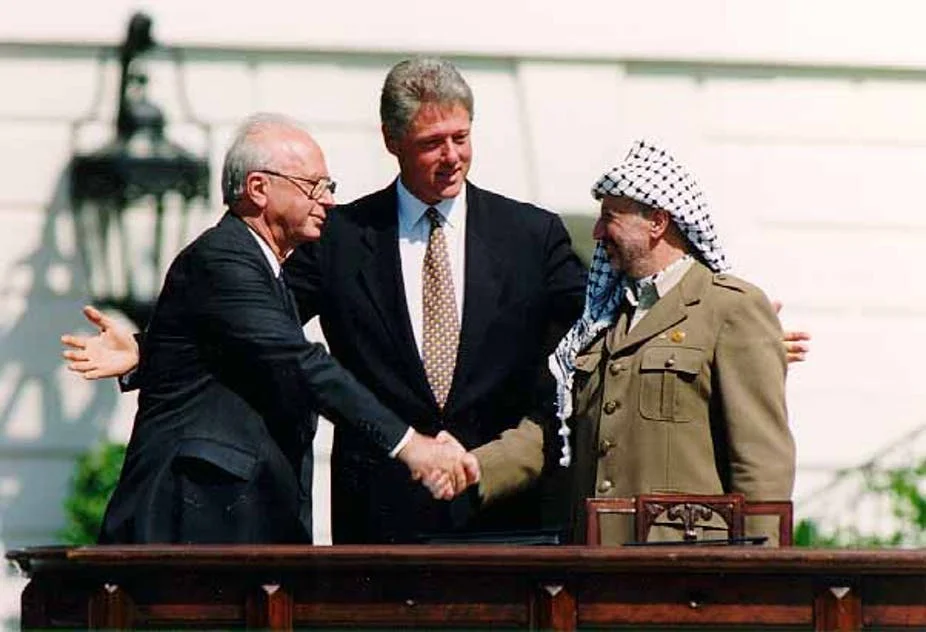 US President Bill Clinton, Israeli Prime Minister Yitzhak Rabin and Palestinian leader Yasser Arafat sign the historic Oslo accord at the White House in September 1993. Wikicommons/Vince Musi