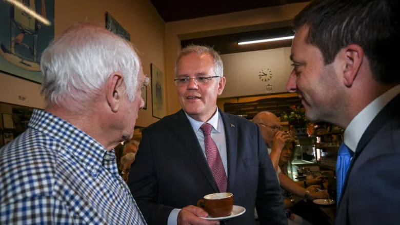 Prime Minister Scott Morrison and Opposition Leader Matthew Guy meet Pellegrini's co-owner Nino Pangrazio. Photo: Eddie Jim