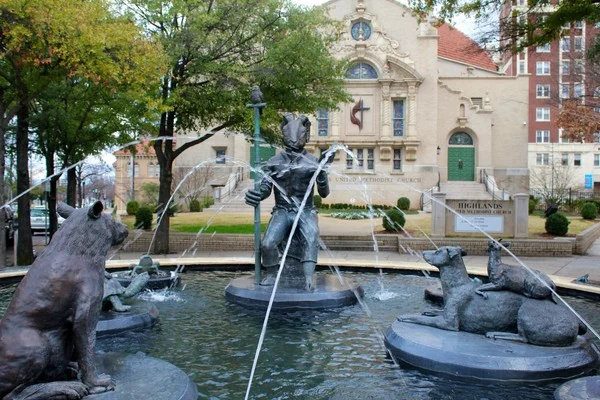 The Storyteller fountain at Five Points South sits in front of the Highlands United Methodist Church