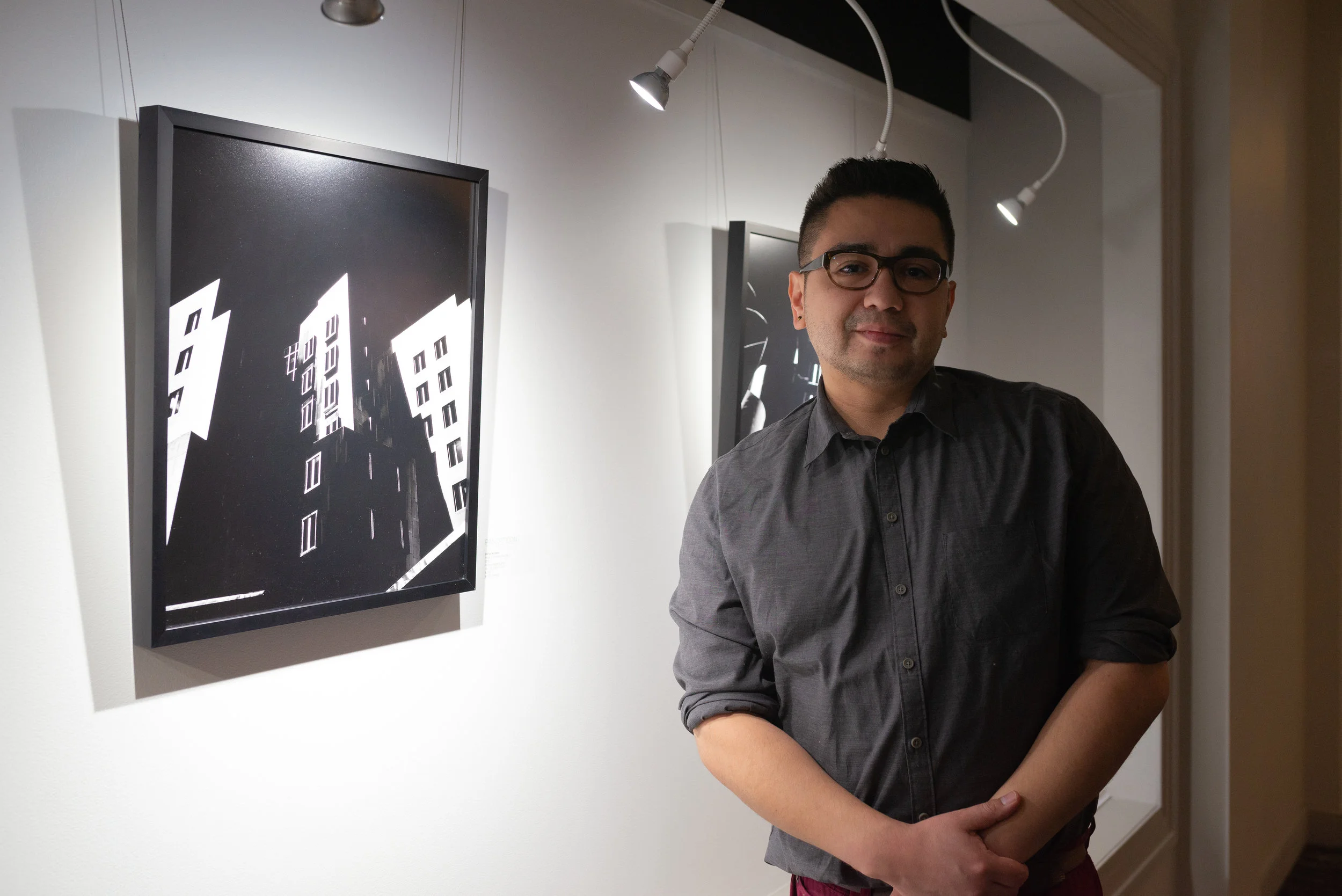 Joshua Seriñana, portrait in front of work
