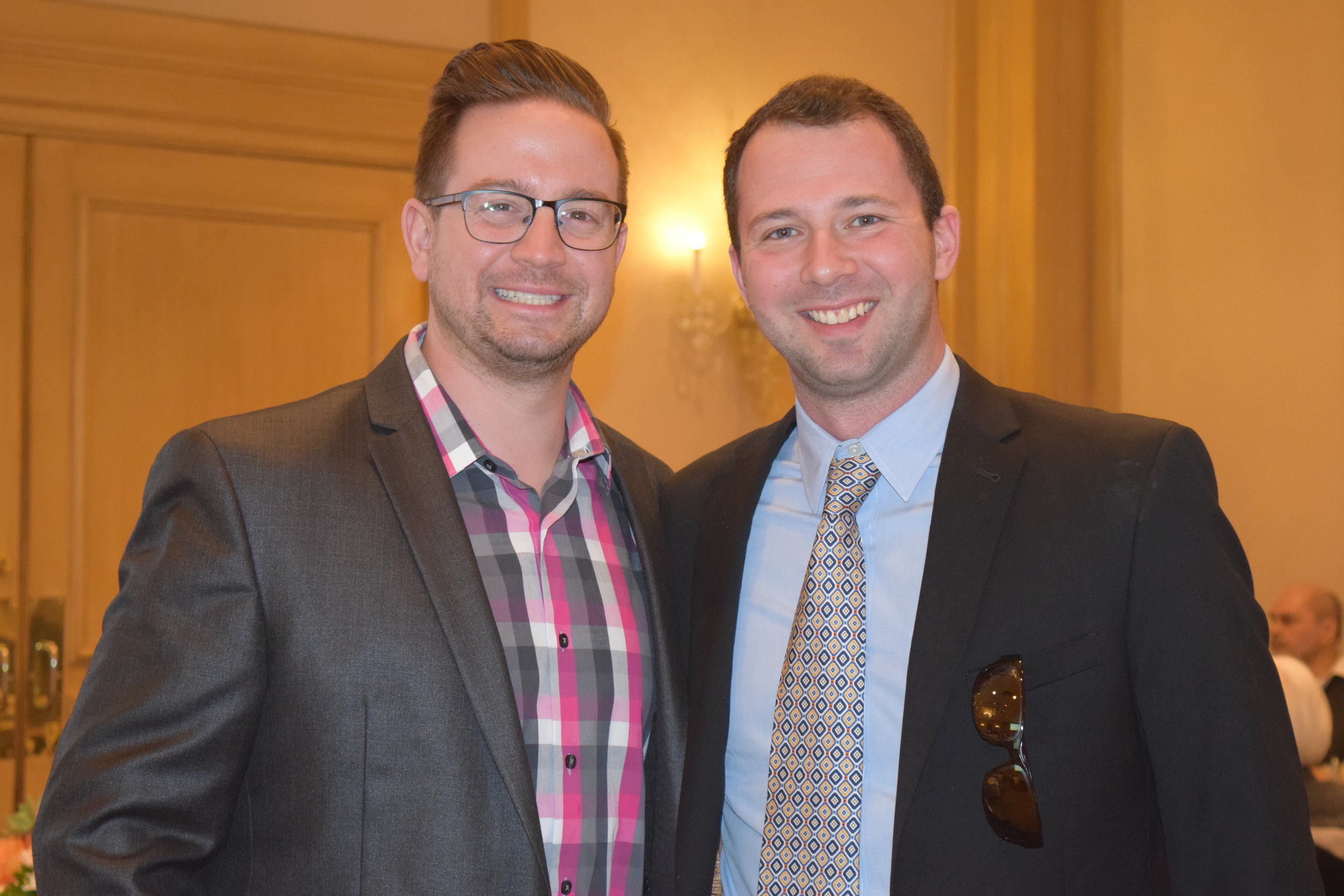  Board member Sam Kaplunov poses with one of his guests. 