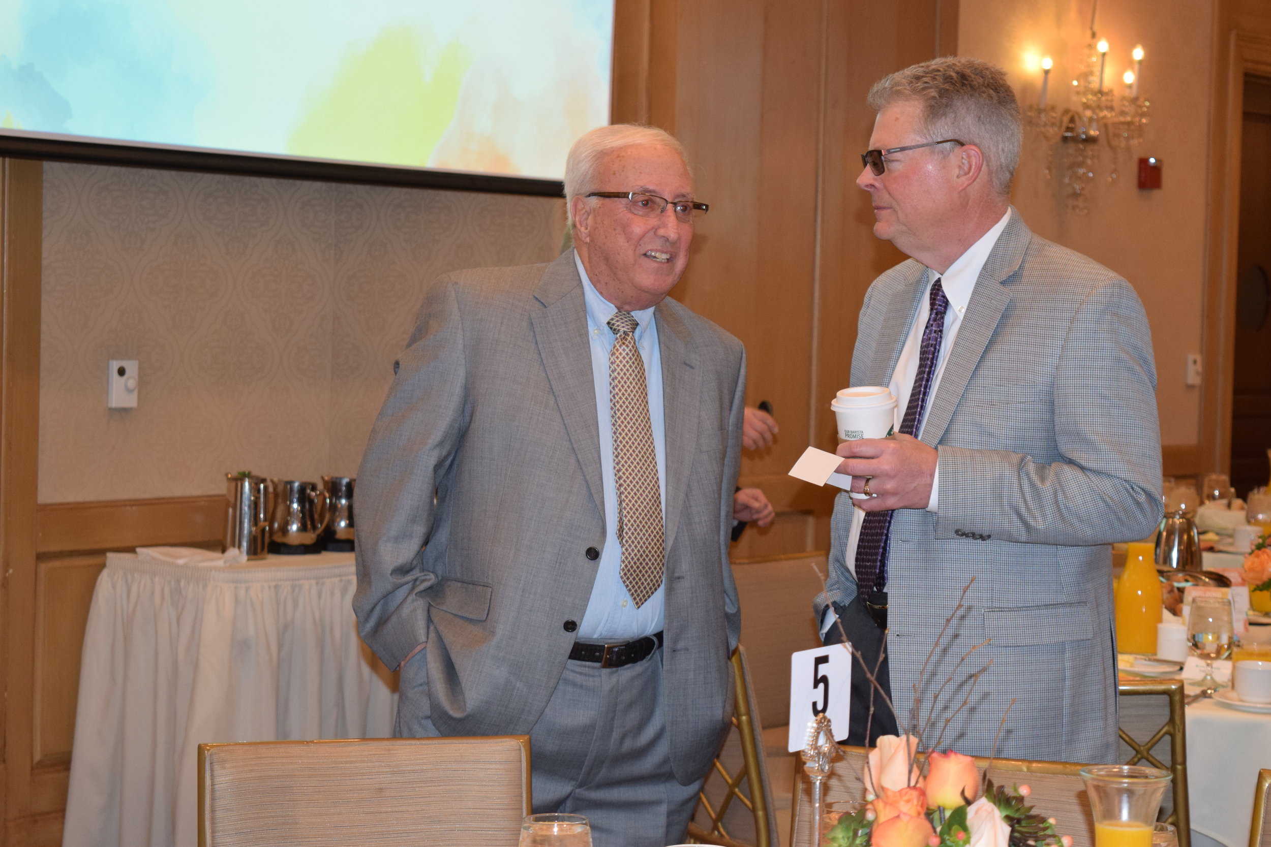  Gary Johnson, president of Plante Moran Trust, speaks to an attendee. 