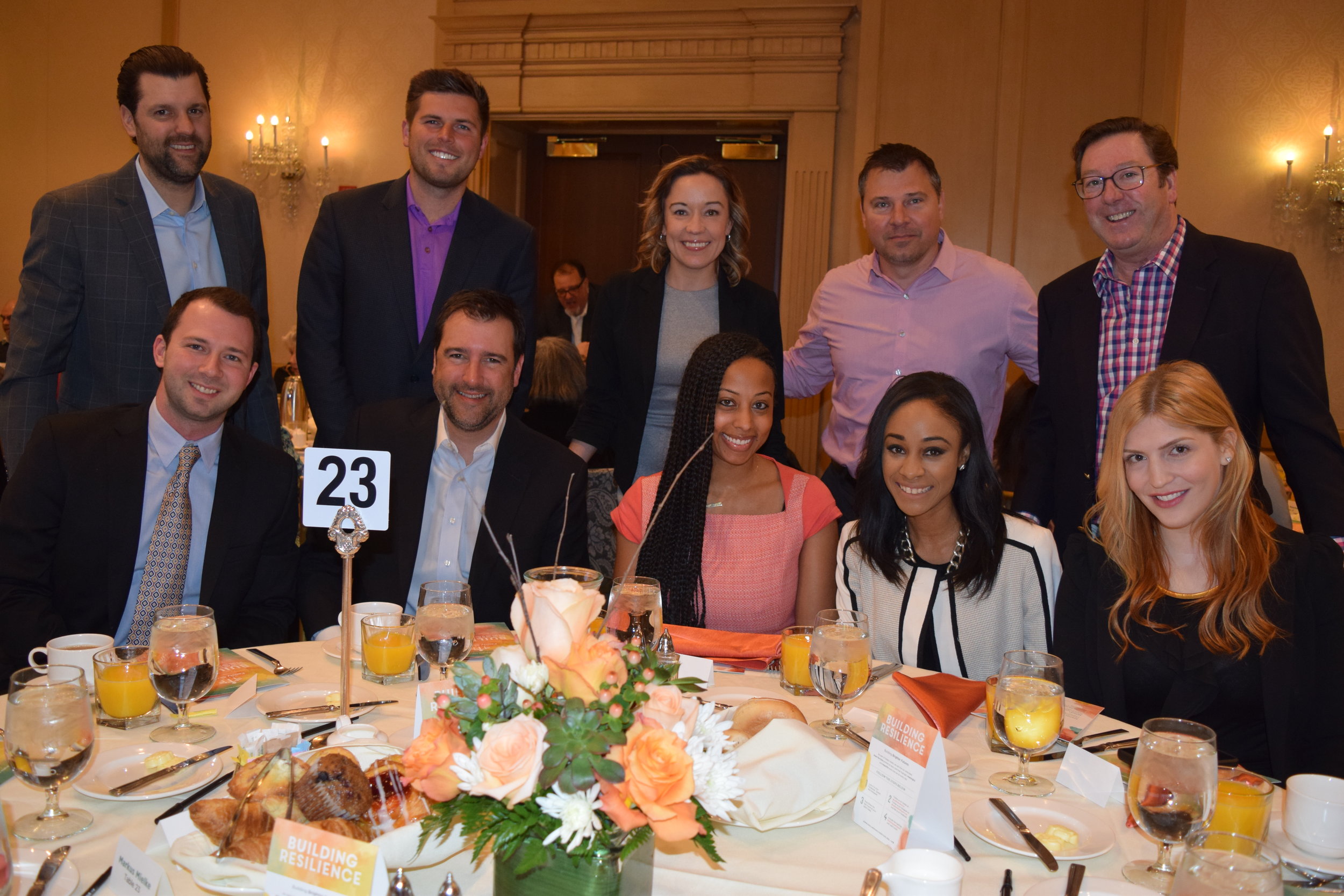  Board member Sam Kaplunov sits with representatives of breakfast sponsor Lee Enterprises and other guests. 