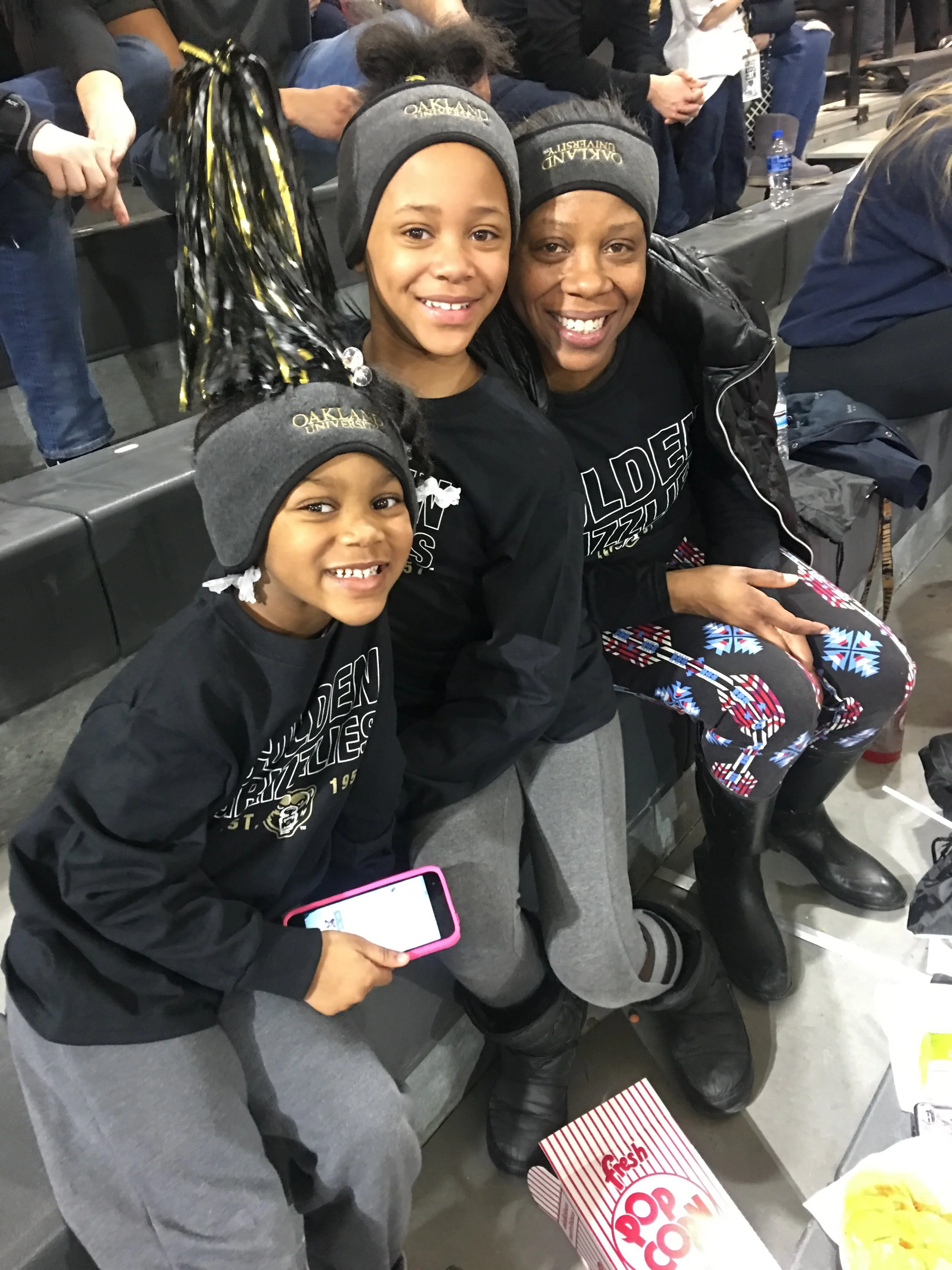 Jamyia Sherrell with her daughters Indigo and Journey at an Oakland University basketball game.