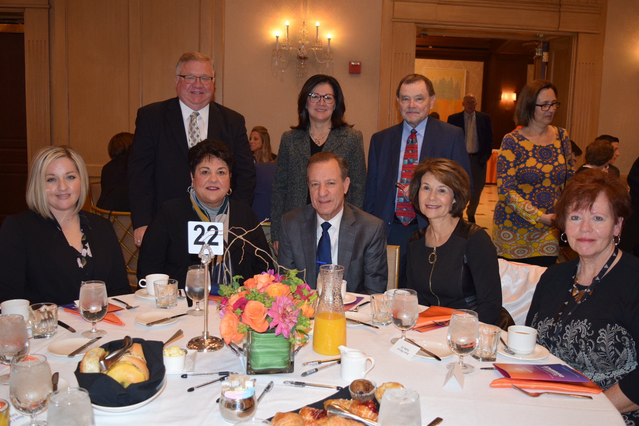 Board member Ron Hillard (top left) of breakfast sponsor Creek Entreprises, joins board member Jean Meyer (front row, second from right) and other representatives of fellow sponsor Ascension.