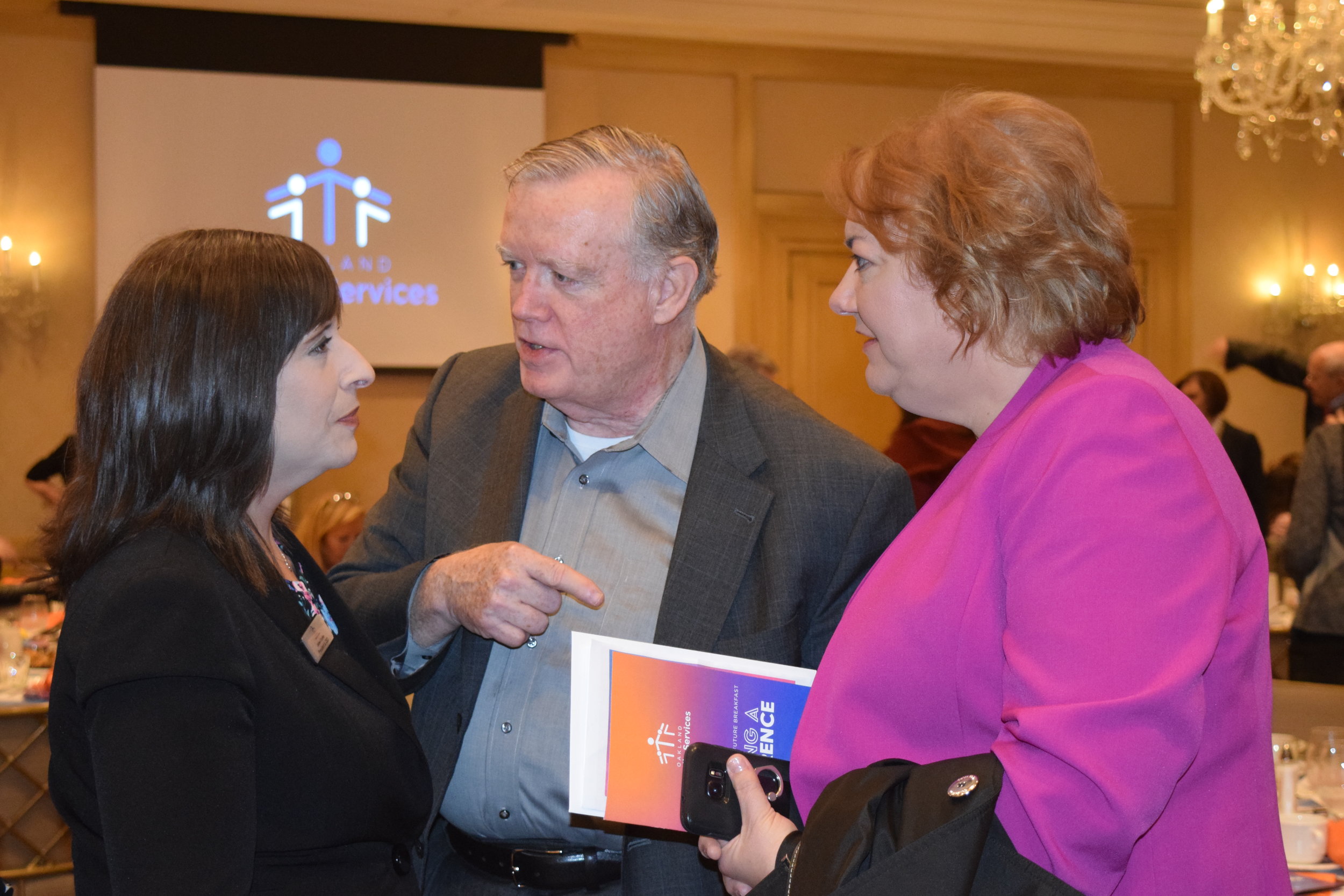 Jaimie Clayton with board member Mike Killian and guest Tammy Willis.